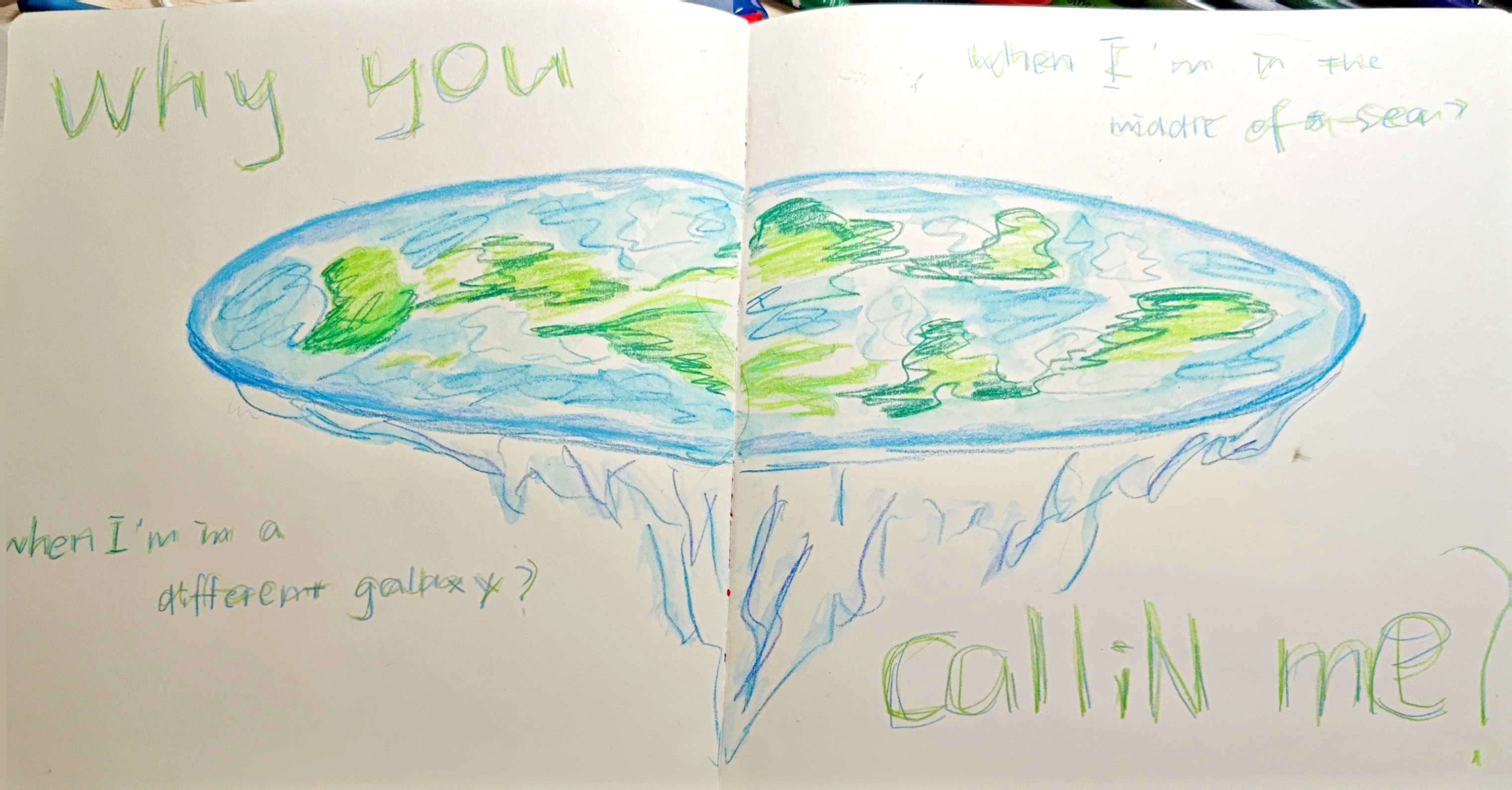 Pale sketchbook spread with a blue-green oval form and handwritten text about being in the ocean.